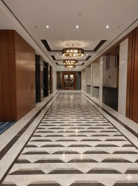 Long corridor with geometric marble floor and warm lighting