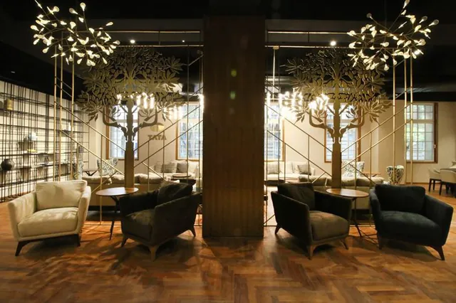 Dining lounge framed by illuminated tree installations