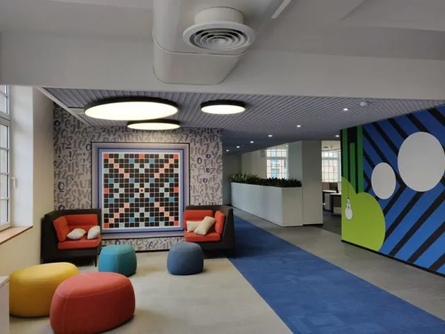 Colourful reception lounge with patterned wall and soft seating