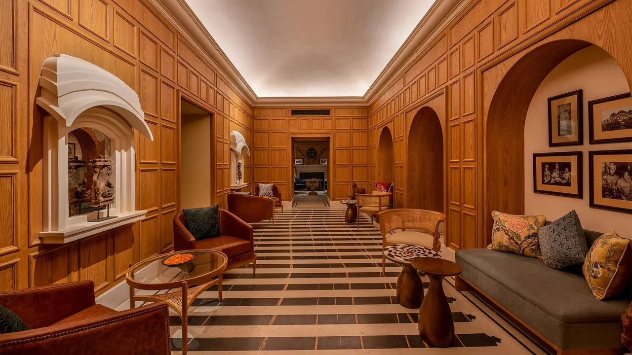 Timber-panelled corridor with arched niches and framed artwork